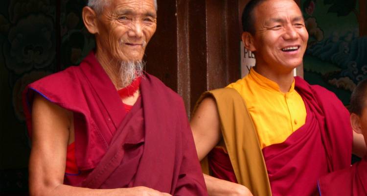 Two monks smiling in traditional robes.