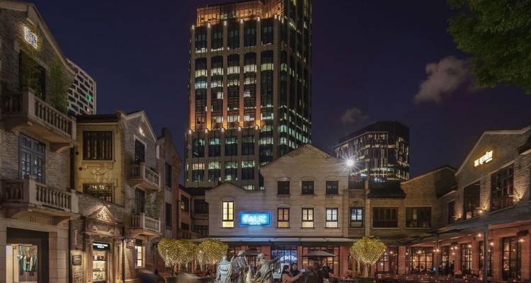 Vue nocturne d'une rue urbaine avec des bâtiments historiques.