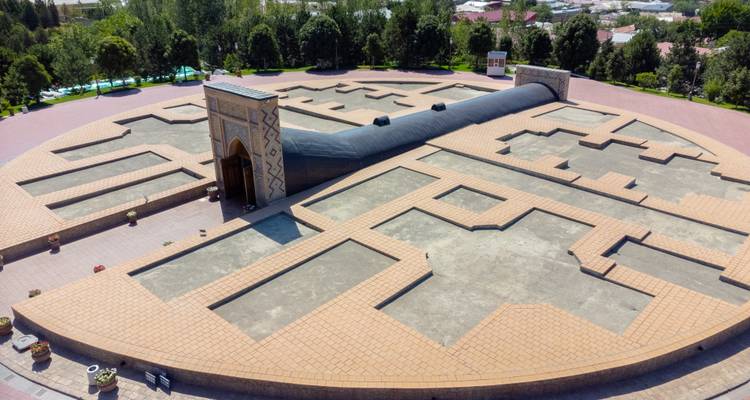 Drone view of a massive ground-level architectural model representing ancient Samarkand observatory layout.