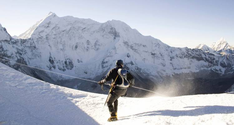 Climber making their way across a snowy landscape.