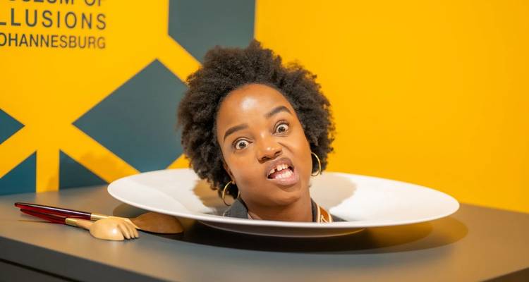 Humorous exhibit where a woman appears with her head on a plate.