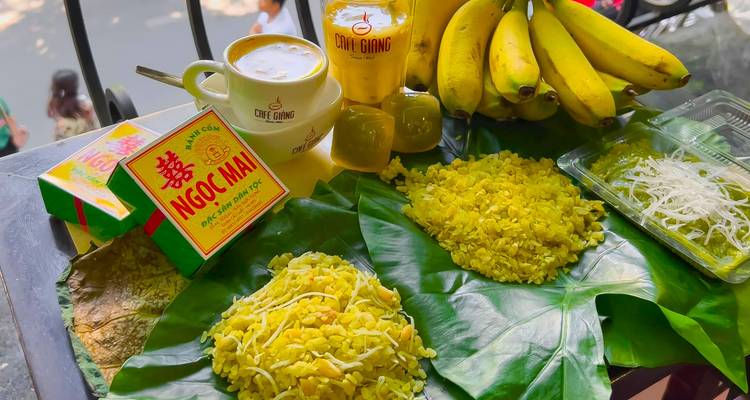 Vietnamese food displayed on banana leaves including bananas and tea.