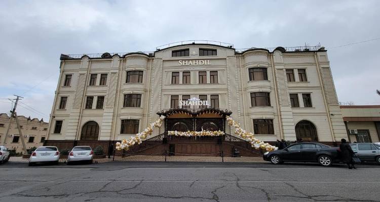 Una vista exterior de un hotel llamado Shahdi con globos decorativos.