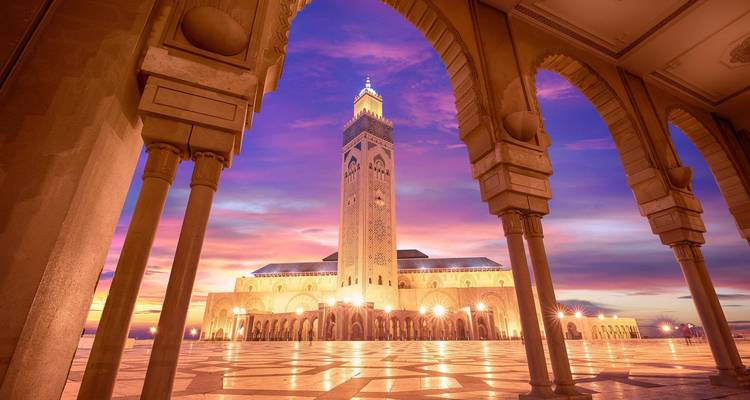 Hassan II Mosque in Casablanca at sunset with vibrant colors.