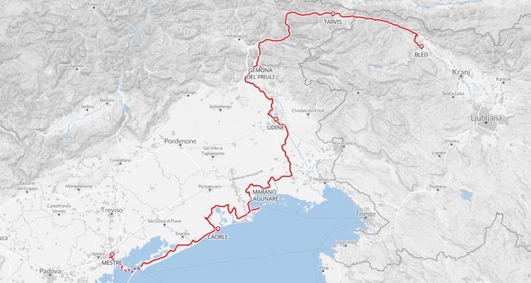 Cycling route map from the Julian Alps to the Adriatic showing a red path across northern Italy and Slovenia.