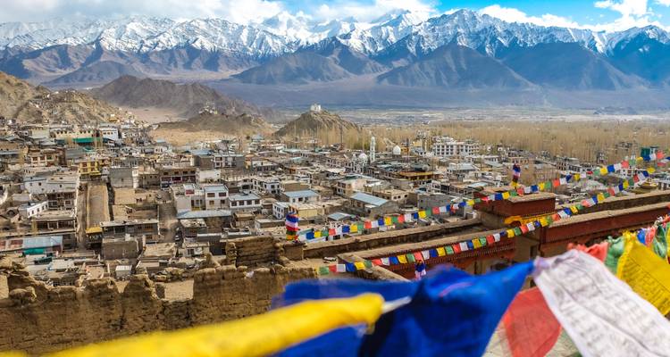 Vista panorámica de la ciudad de Leh con montañas y banderas de oración.