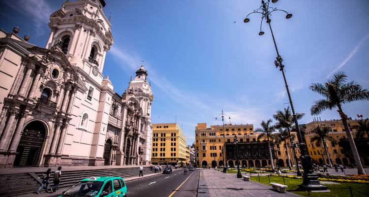 A grand city square with important buildings and palm trees.