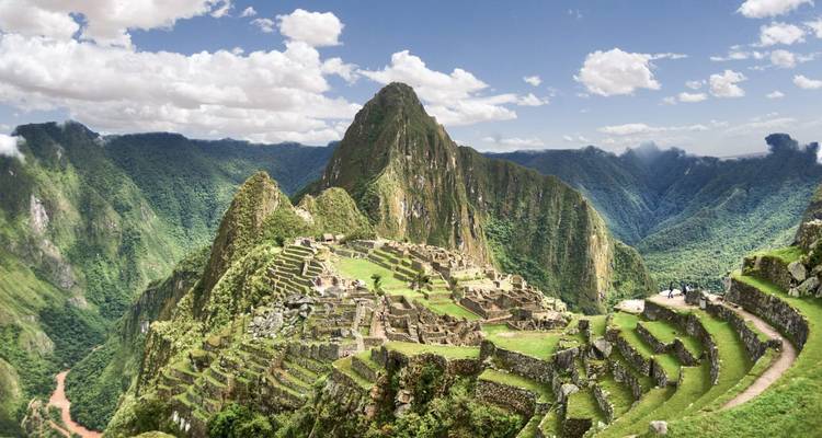 The iconic Machu Picchu ruins with green mountains surrounding.