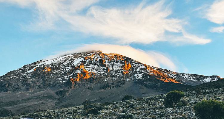 Stunning mountain landscape at sunrise with snow-capped peak.