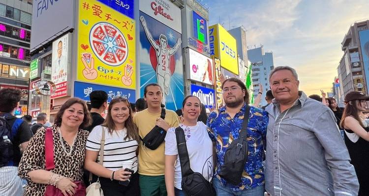 Group of people posing on a busy street in Osaka.