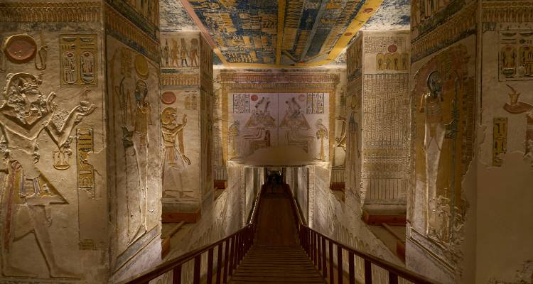A richly decorated ancient Egyptian tomb interior with hieroglyphics.