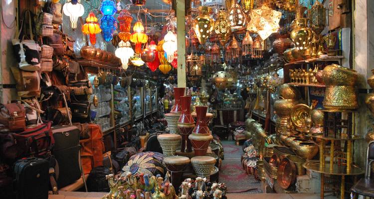 Interior of a shop filled with colorful lamps and brass items.