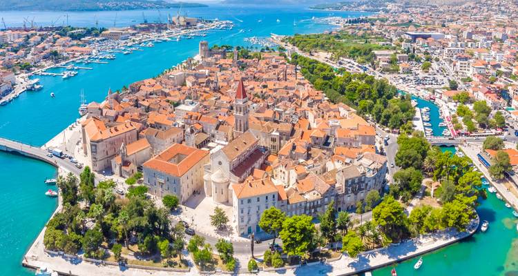 Stunning aerial of Trogir’s walled medieval peninsula surrounded by vivid Adriatic waters and marinas.