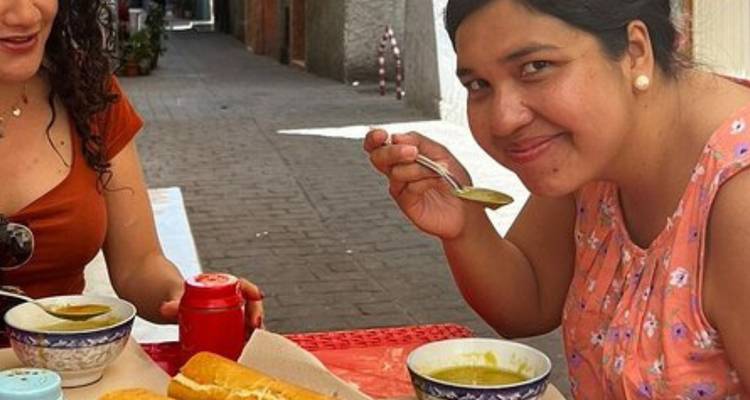 Traveler enjoying a bowl of soup at a small alley café in Morocco.