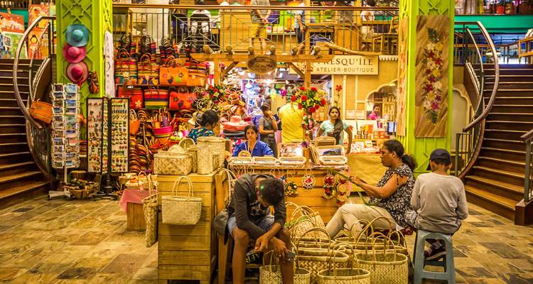Bustling handicraft market stall filled with woven baskets and colourful souvenirs