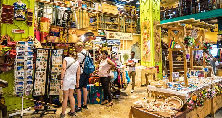 Tourists browsing souvenirs inside a vibrant multi-level craft market