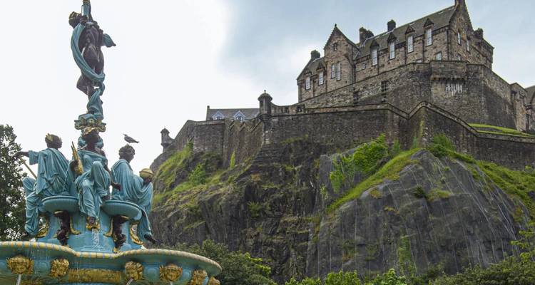 Ross Fountain with Edinburgh Castle looming atop volcanic rock under bright sky