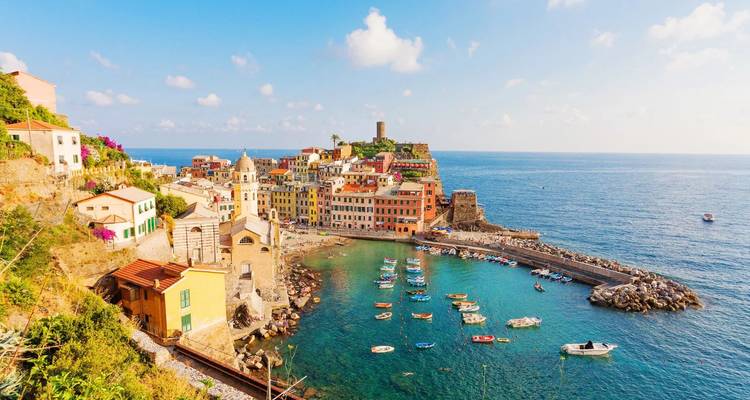 Colorful Vernazza village hugging a rugged Ligurian promontory above turquoise sea