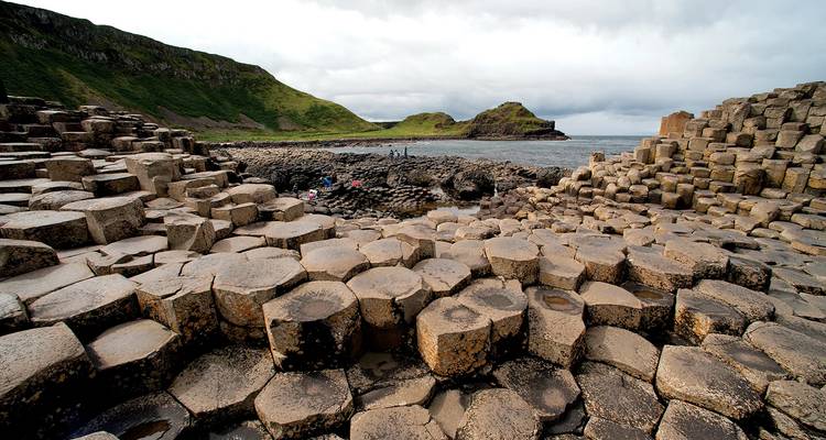 Close-up view of the weathered basalt columns of Giant’s Causeway under cloudy skies.