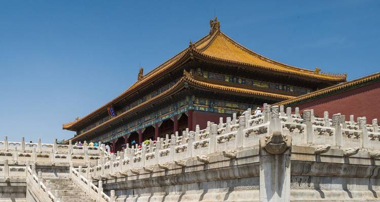Stone terraces and ornate halls of Beijing's Forbidden City under a clear blue sky