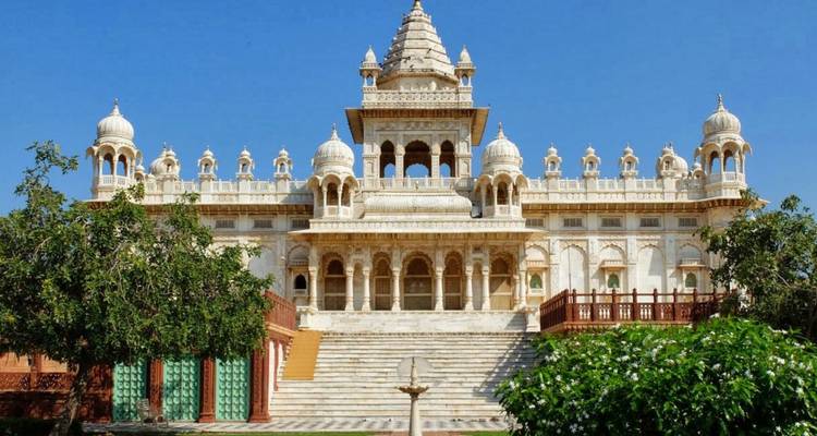 Front view of the intricately carved marble memorial Jaswant Thada under a clear blue sky.