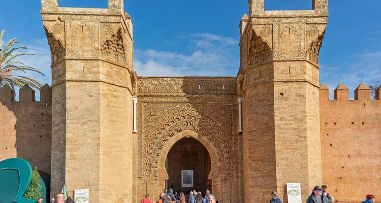 Foule devant la porte ornée de Bab Oudaia aux sculptures complexes à Rabat.
