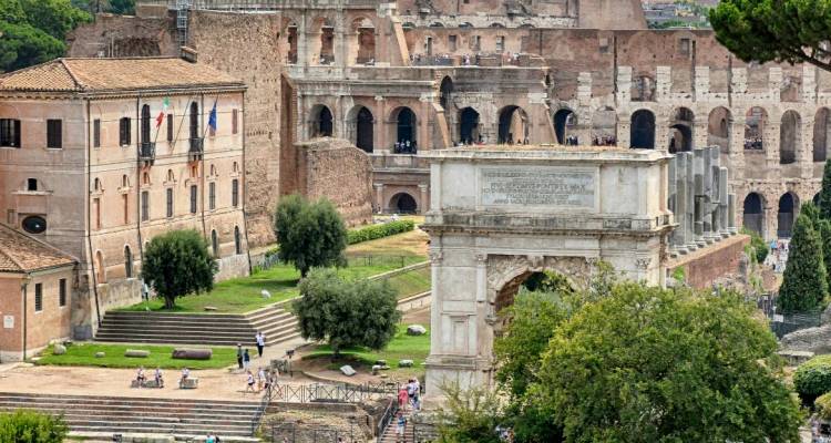 View over the Arch of Titus toward the Colosseum and Roman Forum ruins