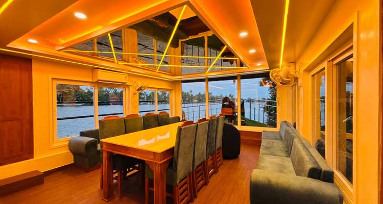 An elegant dining room with mirrored ceiling and soft yellow lighting overlooks tranquil waterways.