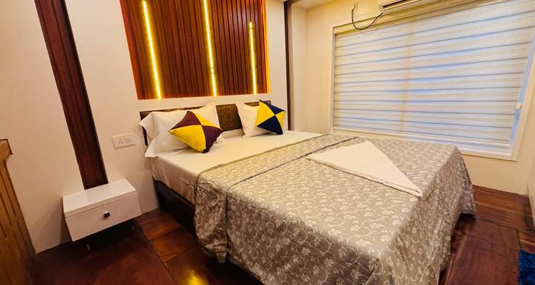 A neatly furnished bedroom with accent pillows and soft lighting aboard the houseboat.