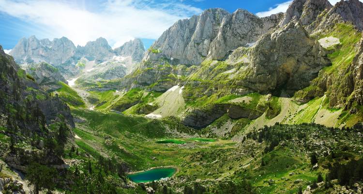 Spectacular high-alpine cirque with rugged limestone peaks and emerald tarns in the Prokletije Mountains.