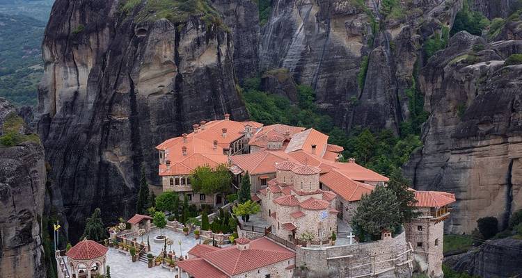 Vista aérea de un monasterio de Meteora encaramado en la cima de gigantescos pináculos de arenisca.