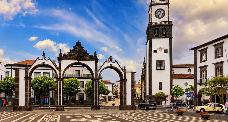 Triumphal arches and white clock tower on a grand square in the Azores capital