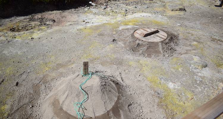 Geothermal cooking pits covered with earth and wooden lids
