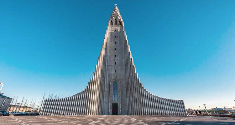 Iconic concrete Hallgrímskirkja church soars into a clear blue Reykjavik sky.