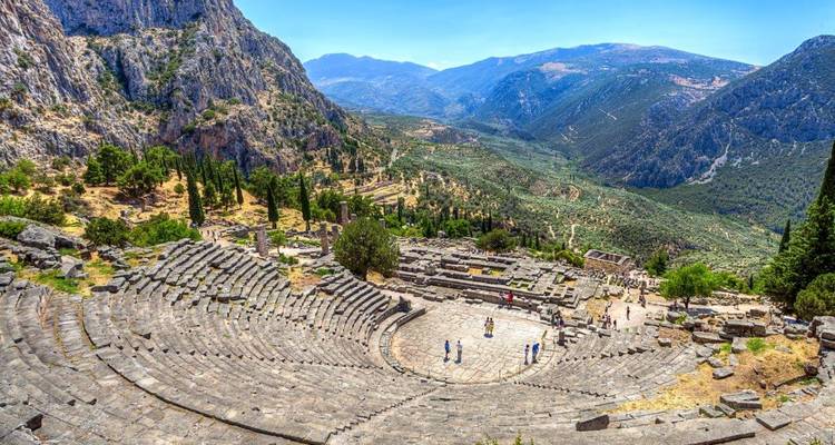 Sweeping amphitheater of Delphi carved into the mountainside overlooking a dramatic valley.