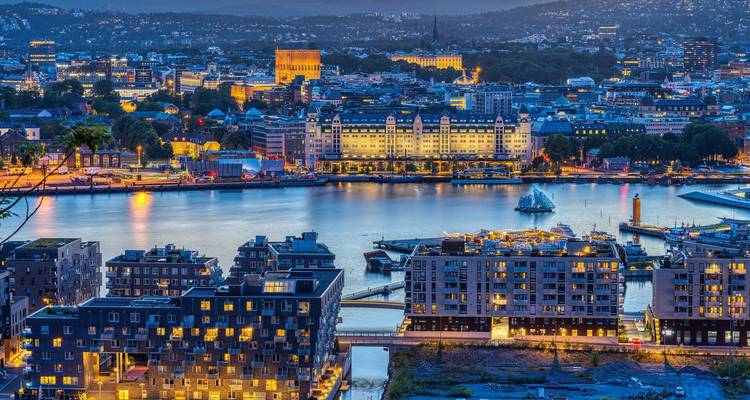Abendpanorama des Osloer Hafens mit Stadtlichtern, die auf dem Fjord schimmern.