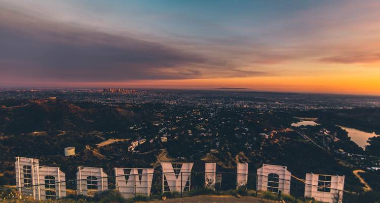 Sunset panorama over Los Angeles seen from behind the iconic Hollywood sign on Mount Lee.