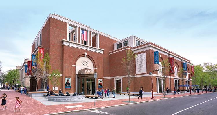 Brick-faced Museum of the American Revolution with visitors gathered outside on a clear day.
