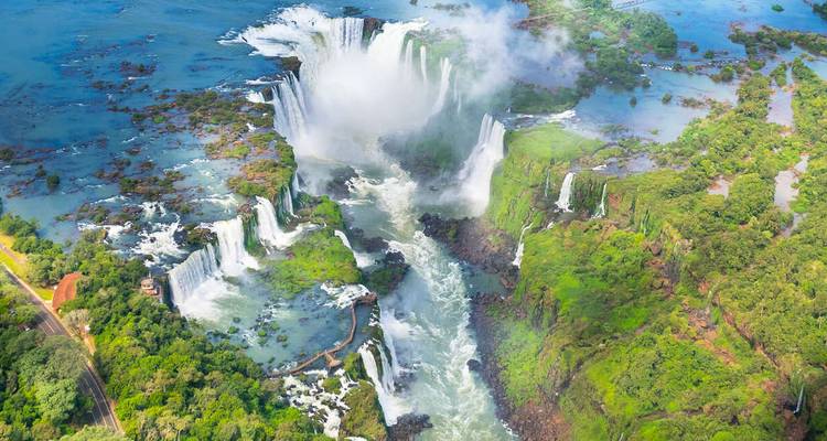 Spectacular aerial view of the entire Iguazu Falls system surrounded by lush jungle