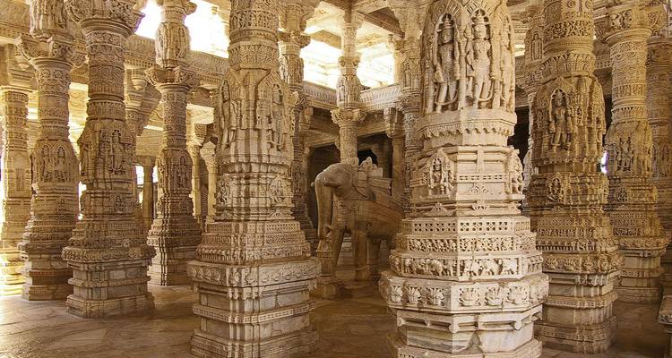 Intricately carved marble pillars inside the Ranakpur Jain Temple, bathed in soft natural light.