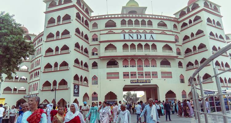 Crowds exiting through the INDIA gate structure at the Wagah border complex after the ceremony.