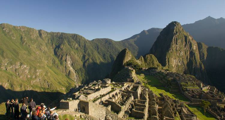 Iconic panoramic view of Machu Picchu ruins surrounded by steep green peaks