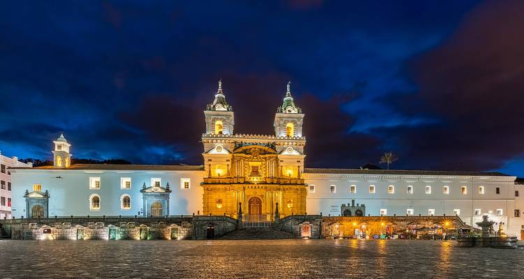 Illuminated San Francisco Church in Quito’s historic center glowing at dusk