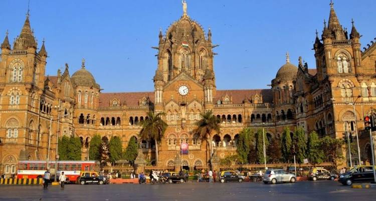 Historic Chhatrapati Shivaji Terminus in Mumbai, its ornate Victorian Gothic facade lit by afternoon sun.