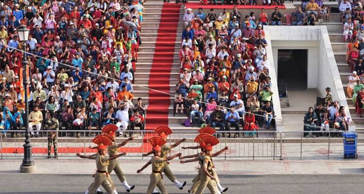 Border guards perform a synchronized high-step parade before packed grandstands at Wagah.