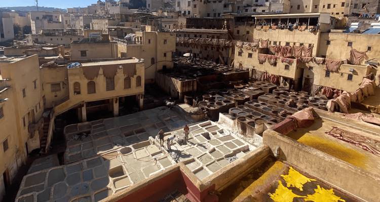 View over the Chouara Tannery vats with workers processing leather.