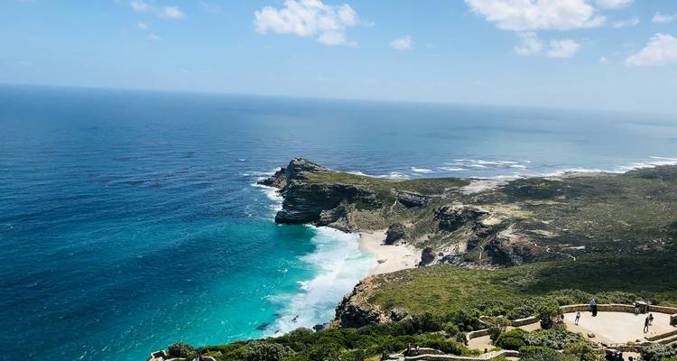 Sweeping view of rugged Cape Point peninsula and bright blue Atlantic waters from above.