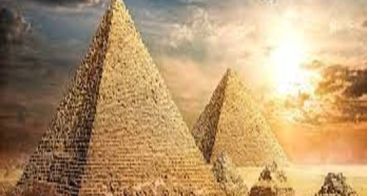 Low-resolution image of two Giza pyramids at sunrise