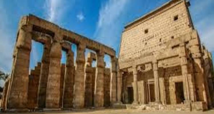Grainy photo of ancient columned temple ruins under blue sky