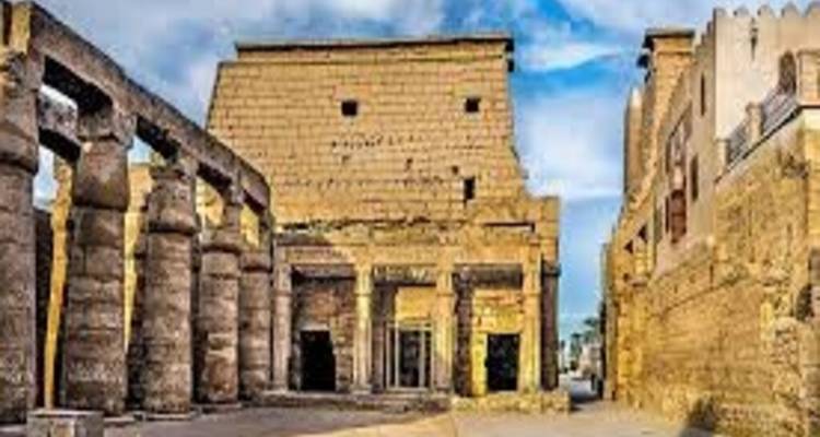 Pixelated view of temple facade flanked by massive columns and stone walls